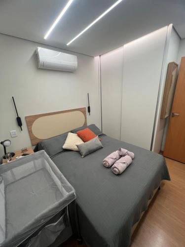 a room with a bed with two towels on it at Apartment Praia Clube Uberlandia in Uberlândia