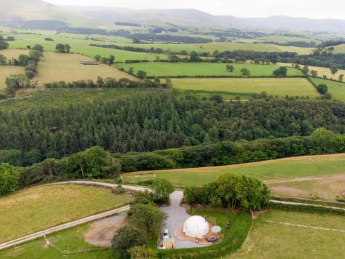 an aerial view of a field with a house at Gwenllian in Machynlleth