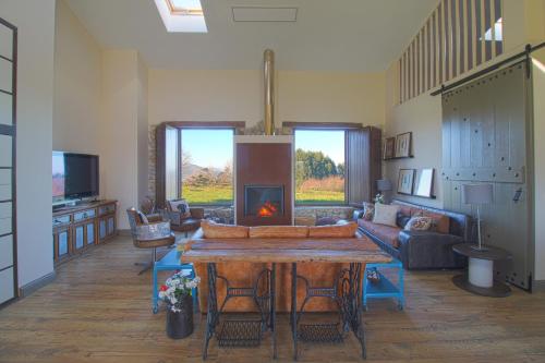 a living room with a table and a fireplace at Casona Alto Sarracin in Lloreda