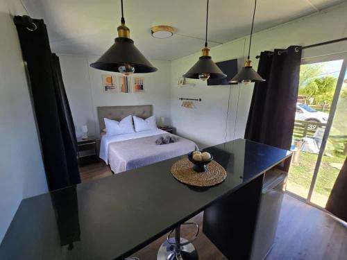 a bedroom with a bed and a table and pendant lights at Maridalba 2 in La Coronilla