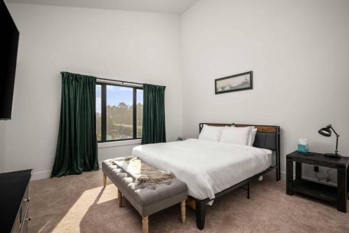 a bedroom with a large bed and a window at Lake & Laughter Unit 2 in Rockaway Beach