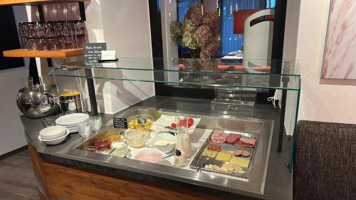 a glass display case with food in it at Boutique - Hotel Zum Schloss in Amtzell