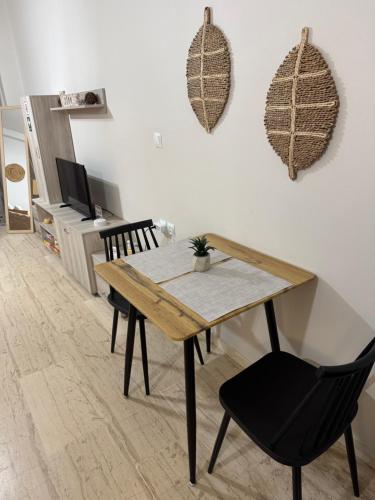 a dining room with a wooden table and a chair at Central House Karistos in Karistos