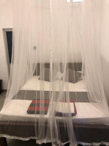 Ένα ή περισσότερα κρεβάτια σε δωμάτιο στο Green House Ahangama