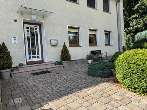 a house with a brick patio in front of a door at Nest,Ruhe und Erholung in Castrop-Rauxel