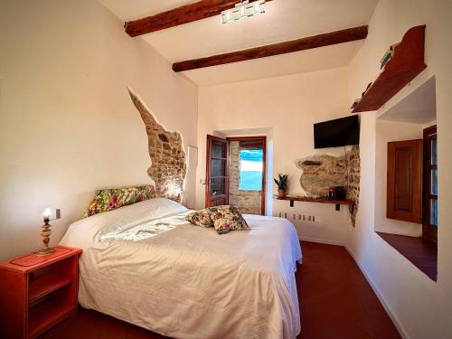 a bedroom with a bed in a room with a window at Borgo La Capraia in Castelfranco Piandisco