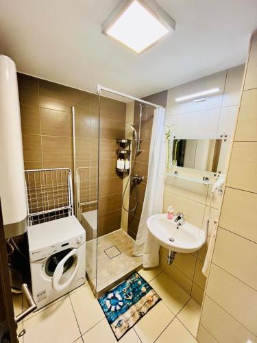 a bathroom with a shower and a sink at Siófok Panoráma Apartman in Siófok