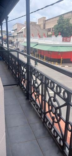 a black railing on a bridge over a street at Stylish Bachelor with Oak Floors & View in Johannesburg