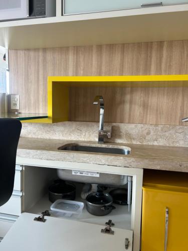 a kitchen with a sink and a counter top at Apart estiloso! in Feira de Santana