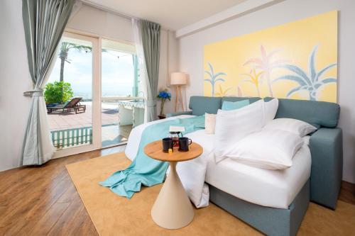 a bedroom with a large bed and a table at Oceanfront Colonial Beach Villa 6Bedrooms, Sleeps 28 in Hua Hin
