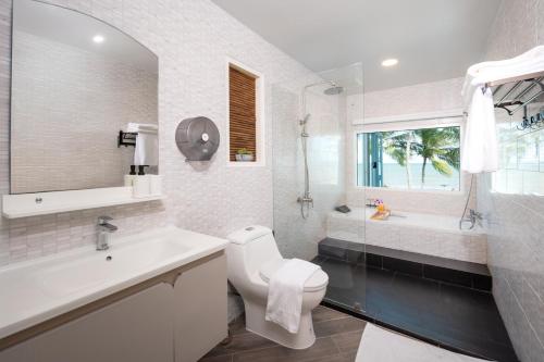 a bathroom with a sink and a toilet and a shower at Oceanfront Colonial Beach Villa 6Bedrooms, Sleeps 28 in Hua Hin