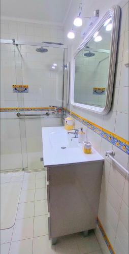a bathroom with a sink and a shower at Villas Terrace Apartment in Praia de Mira