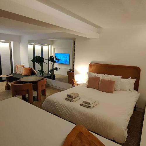 a bedroom with a large bed and a dining room at London loft by let it b travel in London