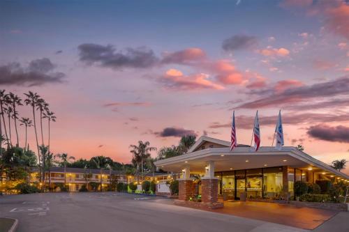 a hotel with american flags on top of a building at Best Western Plus Carriage Inn in Sherman Oaks