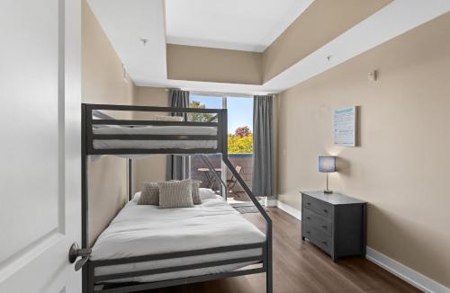 a bedroom with a bunk bed and a window at Experience comfort at Quill Haven - Pet Friendly in Grand Haven