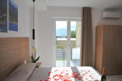a bedroom with a bed and a large window at Domus Fontana in Pompei