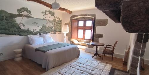 a bedroom with a bed and a window at Manoir de Kerenneur in Plourin