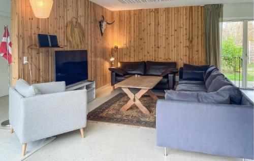 a living room with two couches and a table at Beautiful Home In Sjællands Odde in Yderby
