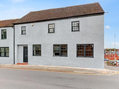 a white building with windows on a street at Apartment 2 - Uk50136 in Stoke on Trent