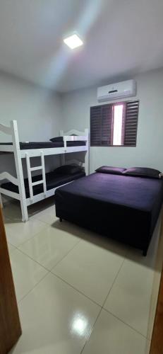a bedroom with a bed and a desk in it at Por ti Maria in Olímpia