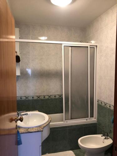 a bathroom with a shower and a sink and a toilet at The Calm Residence - Gondomar 