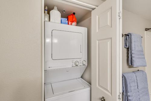 a small laundry room with a washer and dryer at Balcony and Grill Beachfront Lake Havasu City Condo in Lake Havasu City