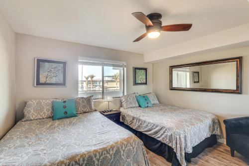 a bedroom with two beds and a ceiling fan at Balcony and Grill Beachfront Lake Havasu City Condo in Lake Havasu City