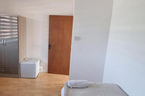 a bedroom with a bed and a wooden floor at Doncaster Dream House Retreat- Sleeps 9 in Doncaster