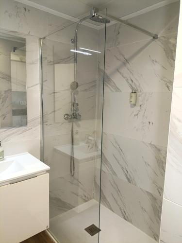 a shower with a glass door in a bathroom at Marynton Boutique in Benicarló