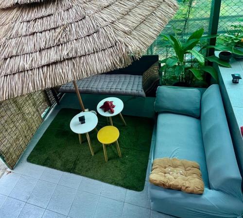 a living room with a blue couch and a table at House&Spa in Koh Phangan