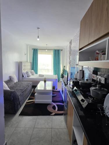 a living room with a couch and a table at Be Happy Homes Tsavo Fedha 513 in Nairobi
