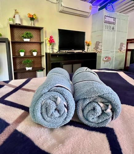 a room with a bed with blue towels on it at House & Spa Tropical Home with Private Jacuzzi Koh Phangan in Ko Phangan