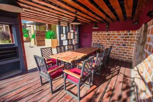 a wooden table and chairs on a deck at Infinity Apartments in Lusaka