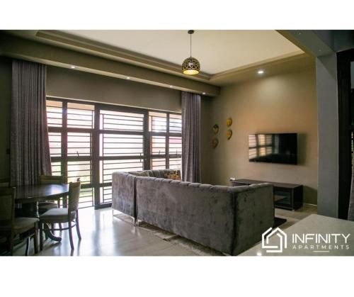 a living room with a couch and a table at Infinity Apartments in Lusaka