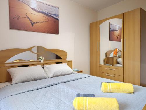 a bedroom with a large bed and a mirror at Mladost the City of Fountains Vitosha View in Sofia
