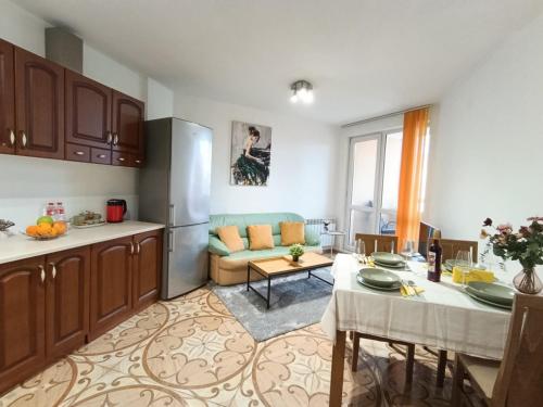 a kitchen and a living room with a table at Mladost the City of Fountains Vitosha View in Sofia