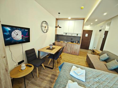 a living room with a couch and a table at Harmony, Residence Hill A85 in Kopaonik