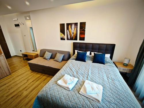 a bedroom with a bed and a couch at Harmony, Residence Hill A85 in Kopaonik