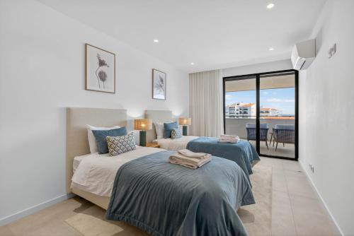 En eller flere senge i et værelse på Vista Lagos Luxury Apartment