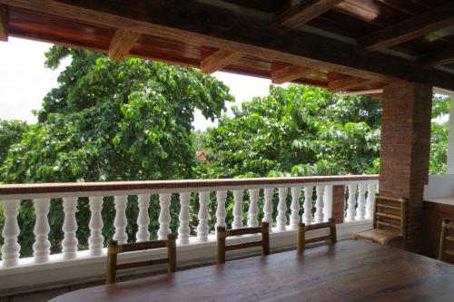 a porch with a white railing and trees at Amihan-Home in Boracay