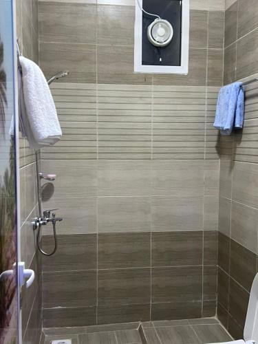 a bathroom with a shower with a glass door at Shahad Guest House in Jebel Shams
