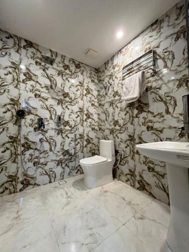 a bathroom with a toilet and a sink at Hr Palace in Varanasi