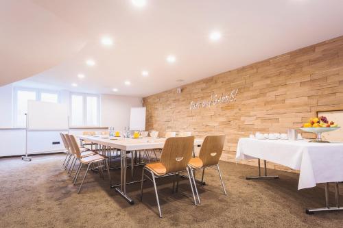 a conference room with a long table and chairs at Hotel - Restaurant Erich Rödiger in Bad Staffelstein