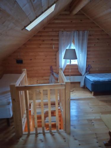 a attic room with a bed and a window at Willa Axe in Hurissalo