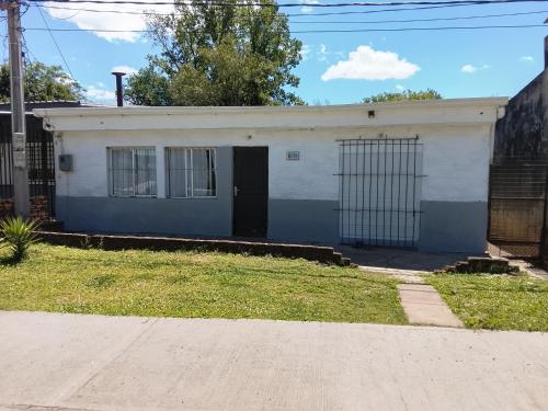 a blue and white building with a gate at Alojamiento Neres in Salto