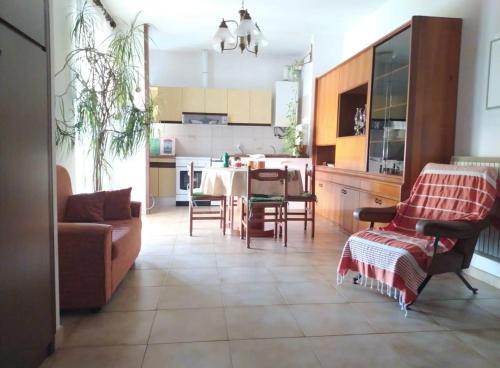 a kitchen and living room with a table and chairs at AllogGio' in Calice Ligure