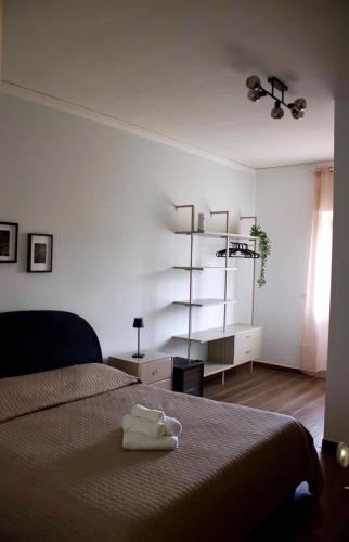 a bedroom with a bed and a dresser and a shelf at Sostal5 in Chiubbica