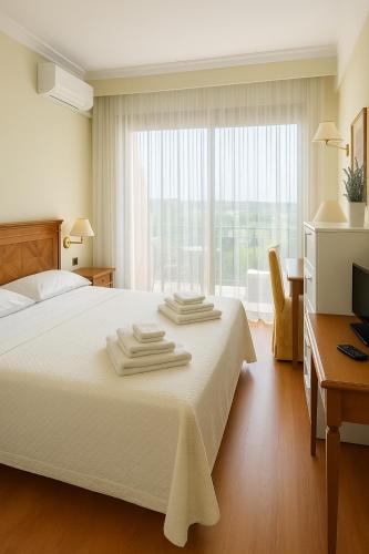 a bedroom with a white bed with towels on it at TatyHouse in Rome