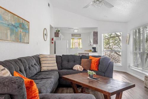 a living room with a couch and a table at Spacious Cabin Rental Overlooking the Guadalupe River near Austin, Texas in Fourth Crossing