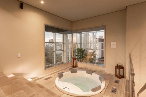 a large room with a large window with a bath tub at 413 Trend Residence High Standard in Porto Alegre